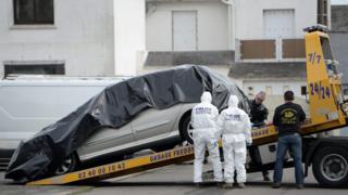 Forensic investigators are at work near the car of Sebastien Troadec after it was found in a parking lot in Saint-Nazaire