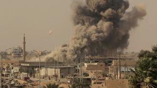 Smoke rises from fighting involving Islamic State group militants and Syrian forces in Raqqa, Syria, this week
