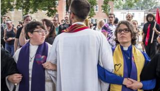 Clergy leaders lock arms at Emancipation park prior to the Unite the Right Rally on August 12, 2017 in Charlottesville