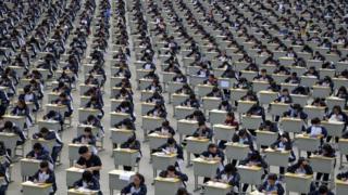 Students take an examination on an open-air playground at a high school in Yichuan, Shaanxi province 11 April 2015.