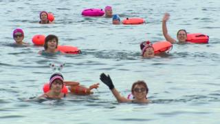 group of swimmers in the sea off the coast of County Down