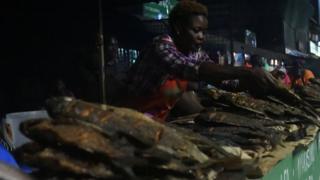 A woman at the Nairobi West fish mongers sell freshly caught and cooked fish on September 18, 2019 in Nairobi.