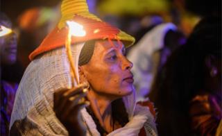 An Ethiopian holds a candle during a lighting ceremony on the eve of the 45th anniversary of the launching of the "Armed Struggle of the Peoples of Tigray", on 18 February 2020 at Mekelle city.
