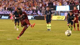 Sadio Mane scores a penalty for Liverpool against Manchester City