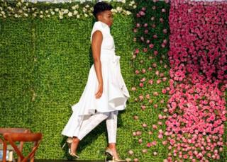 A model presents a wedding dress creation before a TV broadcast of Britain"s Prince Harry and Meghan Markle"s royal wedding at the Windsor Golf Hotel and Country Club in Nairobi, Kenya May 19, 2018