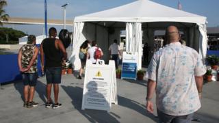 People queue for temperature checks