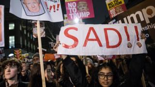 Demonstrators hold placards during protest outside Downing Street, London, against Donald Trump's ban on travel from seven Muslim countries. 30 January 2017