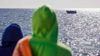 Two African migrants on the Aita Mari looking at to see at a boat full of migrants - Monday 10 February 2020