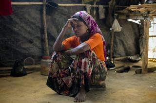 A Rohingya woman in the makeshift house she shares with 6 other refugees at a refugee camp in Cox's Bazar, Bangladesh.