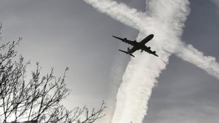 Plane silhouette and contrails