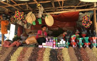 Woman selling incense in a market