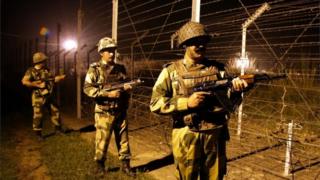 A picture made available on 03 October 2016 shows Indian Border Security Force (BSF) soldiers standing guard during a night patrol near the fence at the India-Pakistan International Border at the outpost of Akhnoor sector, about 40 km from Jammu,