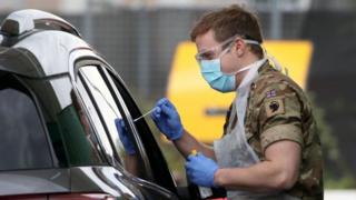 A soldier from 2 Scots Royal Regiment of Scotland assists at a testing centre amid the coronavirus disease outbreak, at Glasgow Airport
