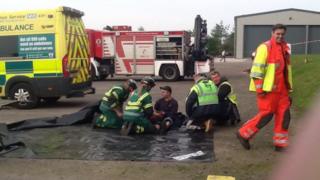 Worker being checked over by paramedics