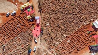 in_pictures This aerial picture shows several funerals being celebrated at the Olifantsvlei Cemetery in Soweto, on July 25, 2020.