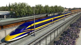 Esta es una imagen proyectada en 3D (no de la vida real) del tren de colores amarillo y azul en ruta por unos rieles en Fresno.