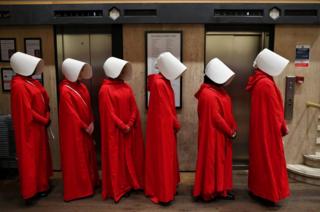 People dressed up as characters from Margaret Atwood's book The Handmaid's Tale