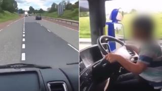 Boy at wheel of lorry