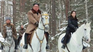 An undated picture released by North Korea's official Korean Central News Agency (KCNA) on 4 December, 2019 shows North Korean leader Kim Jong-un (C) riding a horse as he visits battle sites at Mount Paektu, Ryanggang