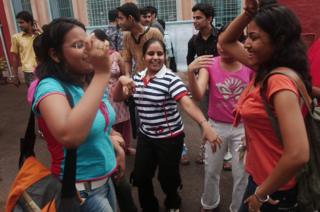 Indian fresher students dance on the first day of Delhi University's new academic year on 17 July 2006.