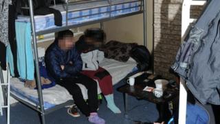 People sat on a bunk bed