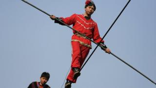 Acrobats perform on a tightrope in Beijing
