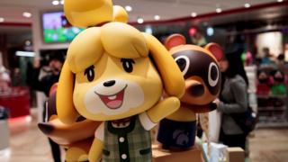 Promotional shop displays show figures of some of Animal Crossing's main characters