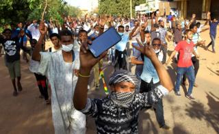 Sudanese demonstrators chant slogans as they march along the street during anti-government protests in Khartoum, Sudan December 25, 2018