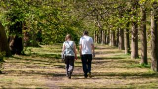 Two people walking in Greenwich Park, London