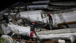 A rescue team works on a collapsed building, following an earthquake in Antakya, Turkey
