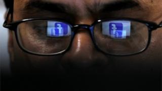 Man looking at Facebook