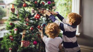 Children taking down Christmas decorations
