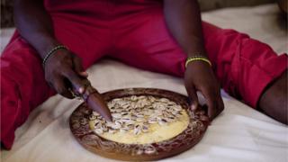 Native doctor with im cowries