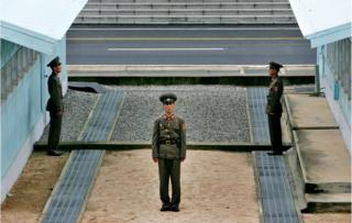 A North Korean soldier stands next to the demarcation line in Panmunjom, on the border between North Korea and South Korea Tuesday 7 Aug 2007