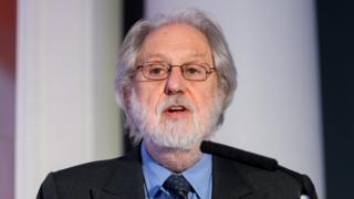 Technology Lord Puttnam is seen speaking from a podium