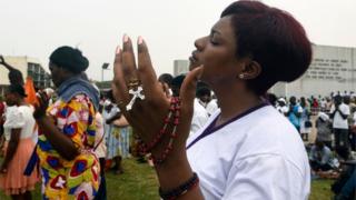 Catholics gather to pray on the premises of the Saint-Paul Cathedral in Abidjan on 15 February 2020.