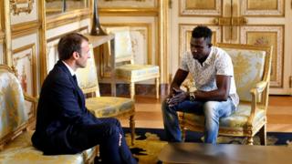 French President Emmanuel Macron (L) meets with Mamoudou Gassama, 22, from Mali, at the Elysee Palace in Paris, France, May 28, 2018.