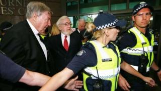 Cardinal George Pell and his lawyer were given a police guard entering court