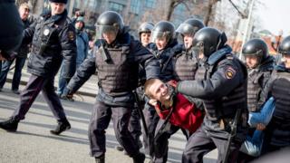 Riot police detain a man during an unauthorised anti-corruption rally in central Moscow, 26 March 2017