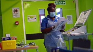 Nurse Princess Kavanire wearing a protective face mask, works on Ward D1 at the Royal Blackburn Teaching Hospital in Blackburn, north-west England on May 14, 2020
