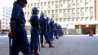 Anti-riot police officers block a road leading to the Democratic Change (MDC) Alliance headquarters in Harare, Zimbabwe, 2 August 2018