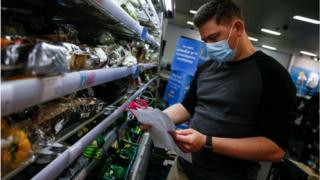 Man wearing a mask in a shop