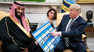 US President Donald Trump (R) holds a defence sales chart with Saudi Arabia's Crown Prince Mohammed bin Salman in the Oval Office of the White House on March 20, 2018