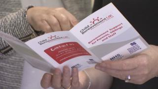 a finger points at a leaflet