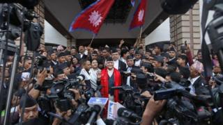 Nepal's newly-appointed prime minister Khadga Prasad Oli (centre) is surrounded by journalists at the Constituent Assembly in Kathmandu (11 October 2015)