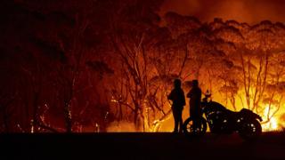 Residents look on at bush fire in Lake Tabourie, Australia on 4 January 2020