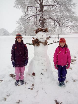 Two girls with a snowman