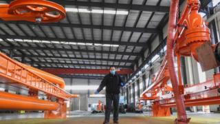 A worker disinfecting machines before workers return to work from holidays at a factory in Lianyungang in China's eastern Jiangsu province.