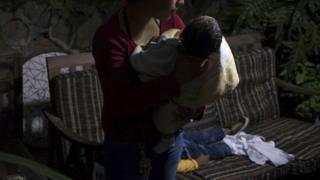 Mujer obligada por las pandillas a cuidar de sus hijos. Foto: Oliver de Ros