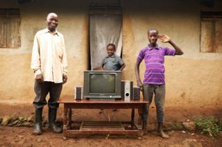 Musingo, 60, with two of his grandsons